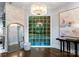 Grand foyer featuring hardwood floors, chic chandelier, elegant decor, and views of the backyard pool at 4714 Ockley Manor Ln, Charlotte, NC 28226