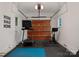 Spacious garage with home gym setup including treadmill, spin bike, and rubber flooring at 4714 Ockley Manor Ln, Charlotte, NC 28226