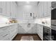 Bright kitchen features white cabinetry, marble countertops, subway tile backsplash, and stainless steel appliances at 4714 Ockley Manor Ln, Charlotte, NC 28226