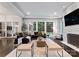 Bright living room with a fireplace, large windows, and plush seating at 4714 Ockley Manor Ln, Charlotte, NC 28226