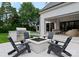 Outdoor patio with a fire pit, built-in grill, pool, and comfortable seating area at 4714 Ockley Manor Ln, Charlotte, NC 28226