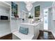 A luxury walk-in closet with custom shelving, ample storage, seating and natural light at 4714 Ockley Manor Ln, Charlotte, NC 28226