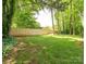 Spacious backyard with lush green grass and a wood privacy fence at 5019 Poplar Glen Dr, Matthews, NC 28104