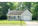 Classic single-story home featuring a well-kept lawn, attached garage, and welcoming front entry at 5019 Poplar Glen Dr, Matthews, NC 28104