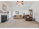 Cozy living room with a fireplace, comfortable seating, and a bright, inviting atmosphere at 5019 Poplar Glen Dr, Matthews, NC 28104