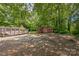 Large backyard with trees, a red shed, and gravel; a metal dumpster is visible on the left at 537 N Main St, Mooresville, NC 28115