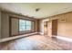 Bedroom with hardwood floors, a large window, neutral walls, and an attached room at 537 N Main St, Mooresville, NC 28115