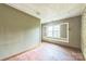Bedroom needing repairs with hardwood floor, light green wall and a window at 537 N Main St, Mooresville, NC 28115