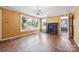 Spacious living room with a decorative fireplace, large windows, and hardwood floors at 537 N Main St, Mooresville, NC 28115