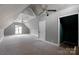 Spacious finished attic features a ceiling fan, a window, and carpeting at 6017 Millbury Ct, Charlotte, NC 28211