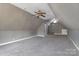 Expansive finished attic space with carpeting, ceiling fans, and neutral paint at 6017 Millbury Ct, Charlotte, NC 28211