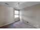 Finished basement showcasing neutral paint, carpeted flooring, and a window with natural light at 6017 Millbury Ct, Charlotte, NC 28211