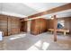 Spacious finished basement area featuring wood paneled walls, built-in shelving, and a classic billiard table at 6017 Millbury Ct, Charlotte, NC 28211