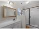 Bright bathroom with a walk-in shower and a large, framed mirror at 6017 Millbury Ct, Charlotte, NC 28211