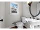 Charming half bath features a pedestal sink and a framed oval mirror at 6017 Millbury Ct, Charlotte, NC 28211