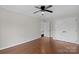Spacious bedroom features hardwood floors, a ceiling fan, and ensuite access at 6017 Millbury Ct, Charlotte, NC 28211
