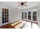 Bedroom with hardwood floors, natural light, and glass paneled door at 6017 Millbury Ct, Charlotte, NC 28211