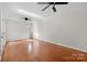 Spacious bedroom featuring hardwood floors and a ceiling fan at 6017 Millbury Ct, Charlotte, NC 28211