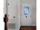 Bright entryway featuring a decorative front door and white trim, leading into the home's interior at 6017 Millbury Ct, Charlotte, NC 28211
