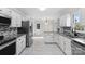 Bright, spacious kitchen with stainless steel appliances, granite countertops, and tile flooring at 6017 Millbury Ct, Charlotte, NC 28211