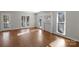Light-filled living room with hardwood flooring and large windows overlooking the yard at 6017 Millbury Ct, Charlotte, NC 28211
