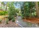 This backyard offers a gravel path that meanders through lush plantings, creating a tranquil and private escape at 6921 Thermal Rd, Charlotte, NC 28211