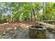Enjoy evenings by the stone firepit in this secluded, wooded backyard, complete with picnic table seating at 6921 Thermal Rd, Charlotte, NC 28211