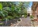 Secluded backyard with mature trees, brick patio, and manicured landscaping at 6921 Thermal Rd, Charlotte, NC 28211
