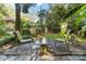 Inviting backyard patio with chairs and a table, set amidst lush tropical plants for relaxation and entertainment at 6921 Thermal Rd, Charlotte, NC 28211