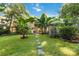Lush backyard featuring tropical foliage and a stepping stone pathway, perfect for a private outdoor retreat at 6921 Thermal Rd, Charlotte, NC 28211