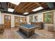 Finished basement with pool table, wet bar, and exposed wood ceiling at 6921 Thermal Rd, Charlotte, NC 28211