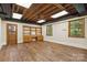 Finished basement featuring plank floors, shelving, and exposed ceiling at 6921 Thermal Rd, Charlotte, NC 28211