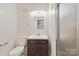 Bathroom featuring modern vanity, wood cabinets, and a glass door shower stall at 6921 Thermal Rd, Charlotte, NC 28211