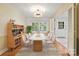 Bright dining room with hardwood floors, modern lighting, and a built-in cabinet at 6921 Thermal Rd, Charlotte, NC 28211