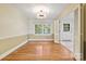 Elegant dining room featuring hardwood floors, modern lighting, and an open doorway leading to another room at 6921 Thermal Rd, Charlotte, NC 28211
