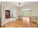 Open dining room connected to the kitchen, showcasing hardwood floors and abundant natural light through large windows at 6921 Thermal Rd, Charlotte, NC 28211