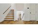 Hallway with wood stairs and stone floors leading to a lower level at 6921 Thermal Rd, Charlotte, NC 28211