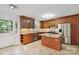 Updated kitchen features granite countertops, stainless steel appliances, and a functional island with seating at 6921 Thermal Rd, Charlotte, NC 28211