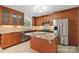 An open kitchen with wooden cabinets, granite countertops, tiled backsplash, and stainless steel appliances at 6921 Thermal Rd, Charlotte, NC 28211