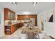 Open kitchen with wooden cabinets, stainless steel appliances, and tiled floor at 6921 Thermal Rd, Charlotte, NC 28211