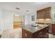 A kitchen with granite countertops, wooden cabinets, a kitchen island, and stainless steel appliances at 6921 Thermal Rd, Charlotte, NC 28211