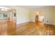 Spacious living room with hardwood floors and seamless transition to other rooms in the house at 6921 Thermal Rd, Charlotte, NC 28211