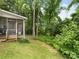 Green backyard with a screened in porch, perfect for relaxation at 705 Torrey Pines Ln, Fort Mill, SC 29715