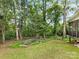 Lush backyard with mature trees and greenery, offering privacy and a peaceful outdoor space at 705 Torrey Pines Ln, Fort Mill, SC 29715