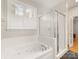 Elegant bathroom with a soaking tub, glass shower, and large window at 705 Torrey Pines Ln, Fort Mill, SC 29715