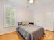 This bedroom features hardwood floors, a ceiling fan, a window with shutters, and neutral-toned walls at 705 Torrey Pines Ln, Fort Mill, SC 29715