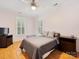 A comfortable bedroom with two windows, a ceiling fan, and wood floors at 705 Torrey Pines Ln, Fort Mill, SC 29715