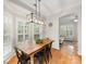 Dining area with an wooden table, black metal chairs, and modern light fixture at 705 Torrey Pines Ln, Fort Mill, SC 29715
