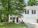 Charming white home featuring a well-kept lawn and inviting front porch with rocking chairs at 705 Torrey Pines Ln, Fort Mill, SC 29715