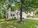 Charming white home featuring a well-kept lawn and inviting front porch with rocking chairs at 705 Torrey Pines Ln, Fort Mill, SC 29715